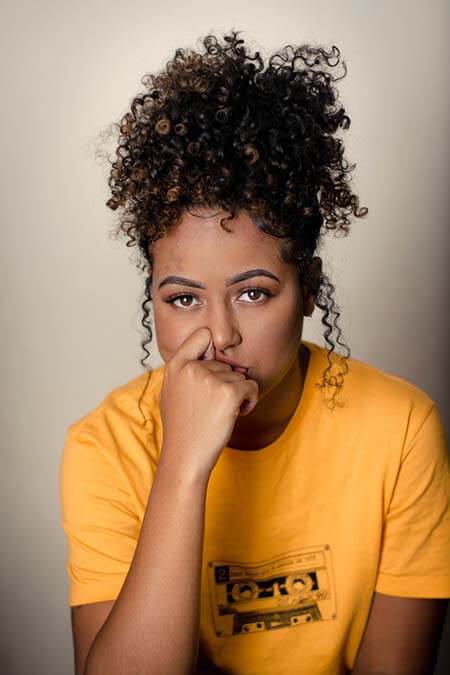 Black woman with Curly Ponytail and baby hairs professional hairstyle