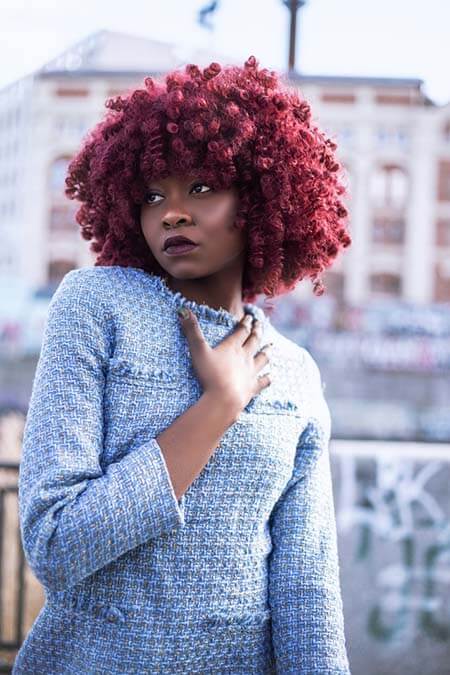 Black woman with colorful Curly professional hairstyle