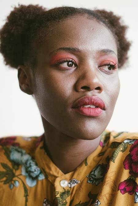 Black woman with two Afro Puffs professional hairstyle