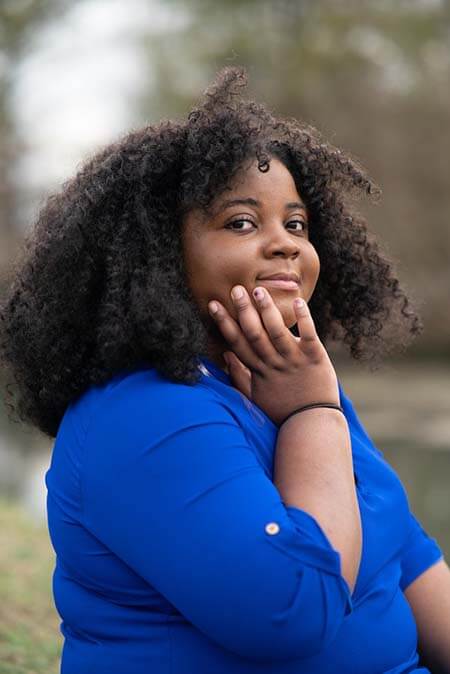 Black woman with Natural Curly professional hairstyle