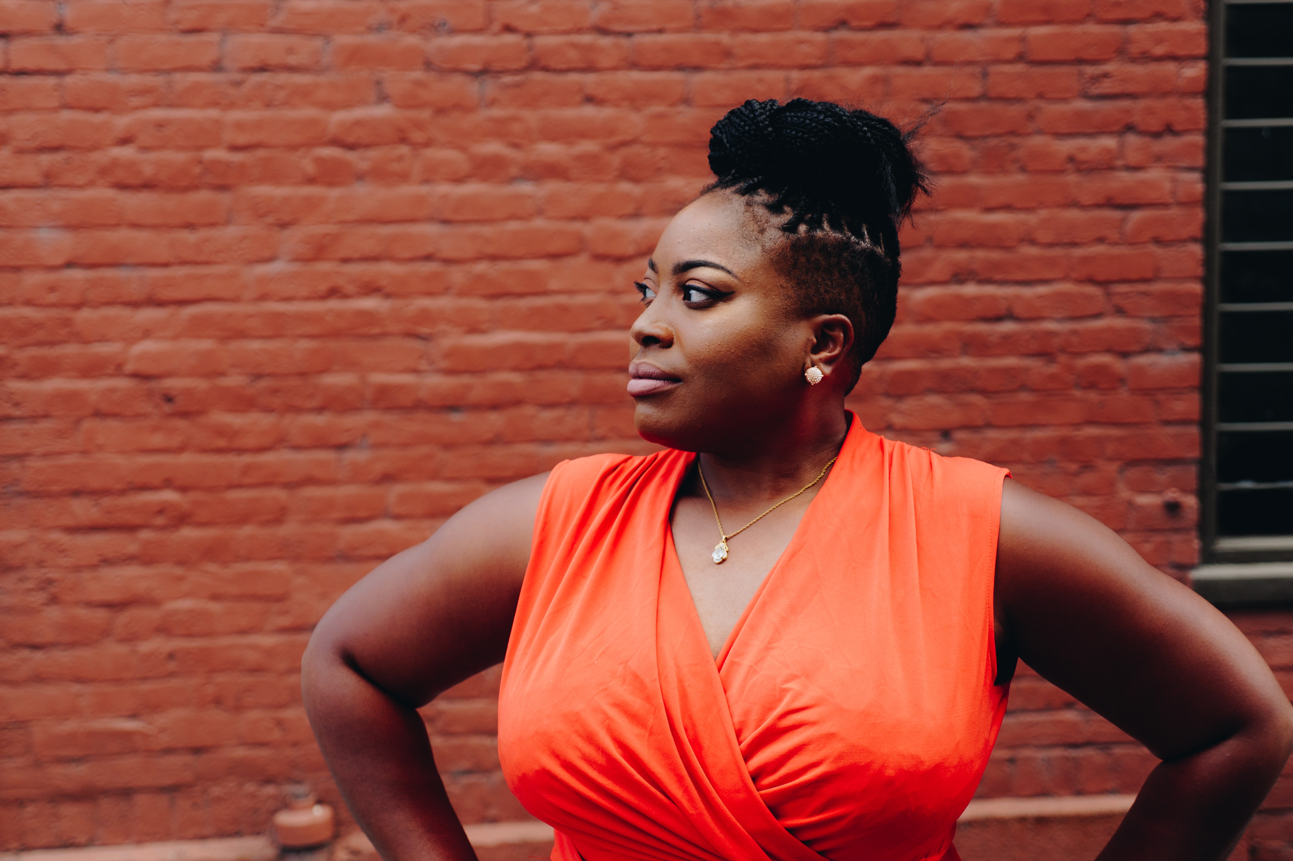 Black woman with individual braids and shaved sides professional hairstyle