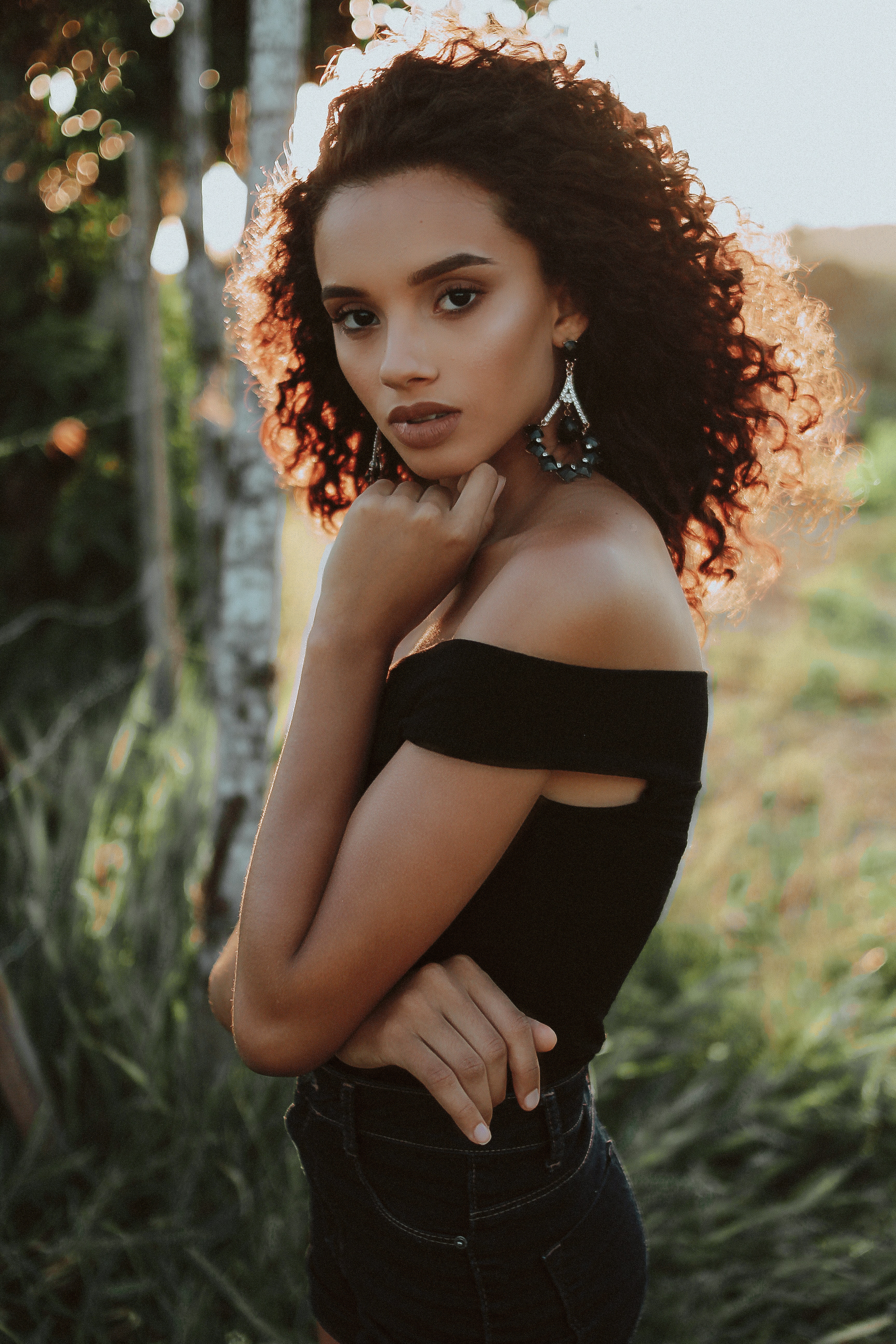 Black woman with medium curly downdo professional hairstyle