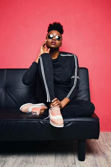 Black woman with high puff on top of head professional hairstyle