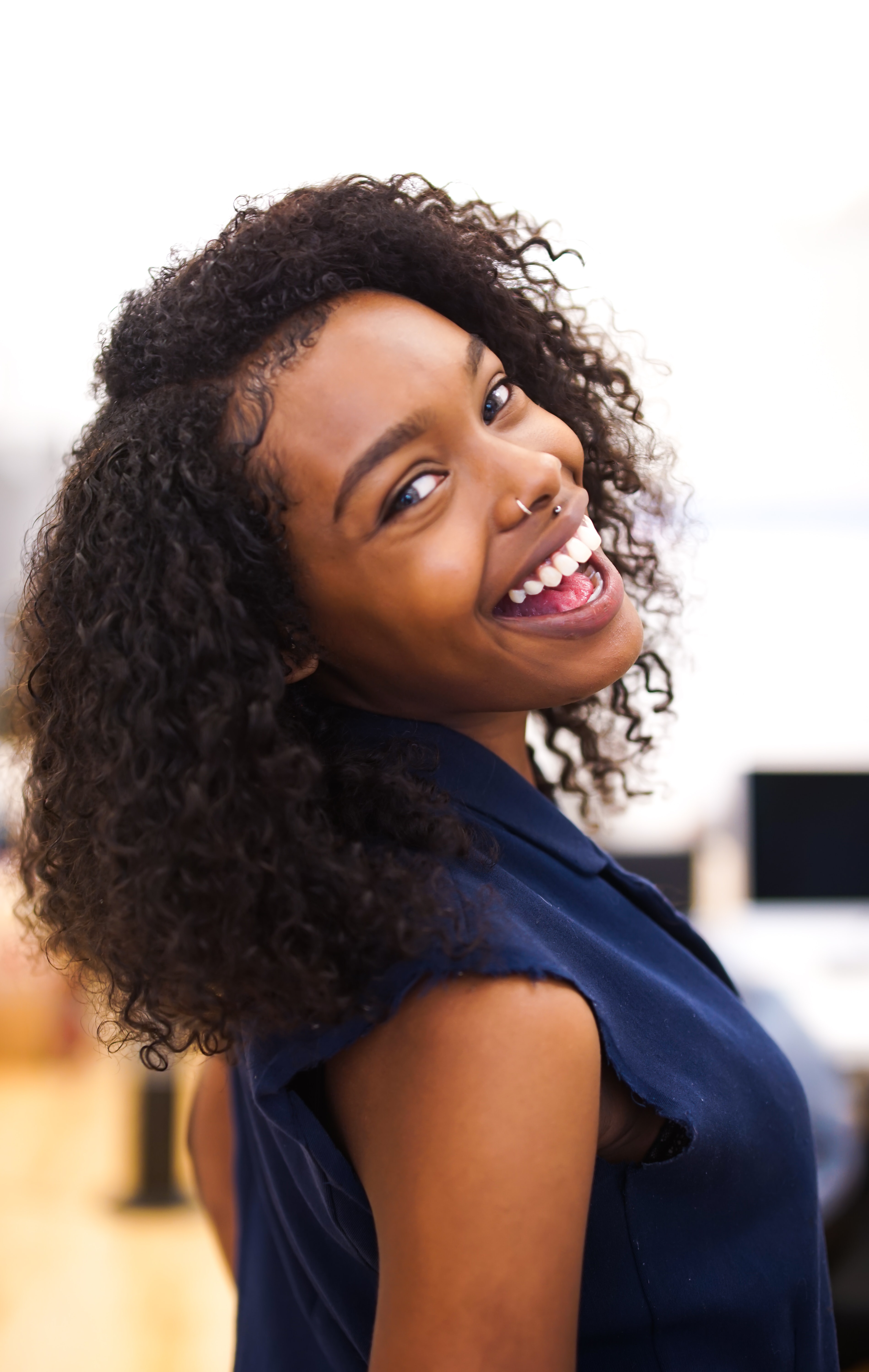 Black woman with Natural Curly Hair and baby hairs professional hairstyle