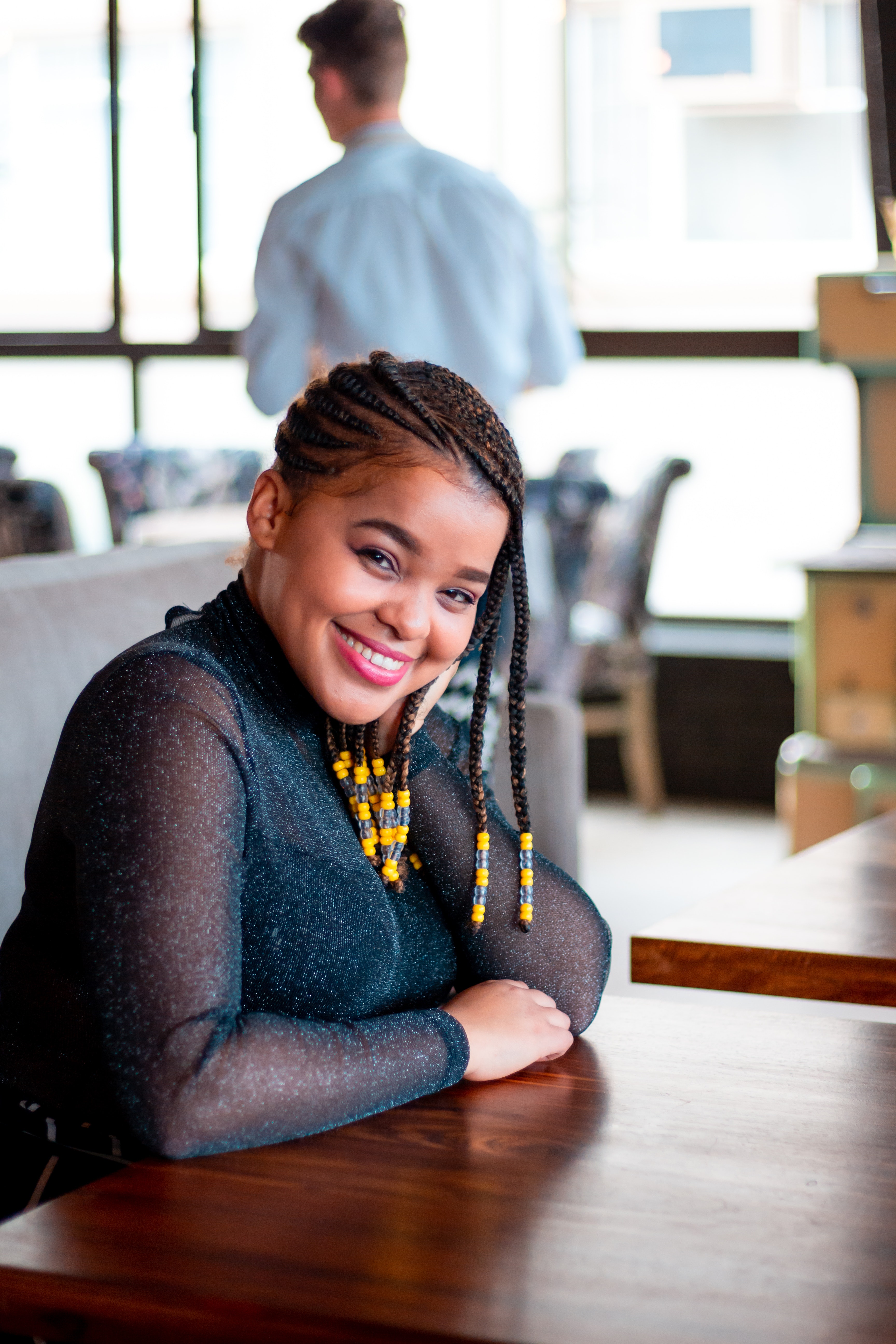 Black woman with side cornrows professional hairstyle